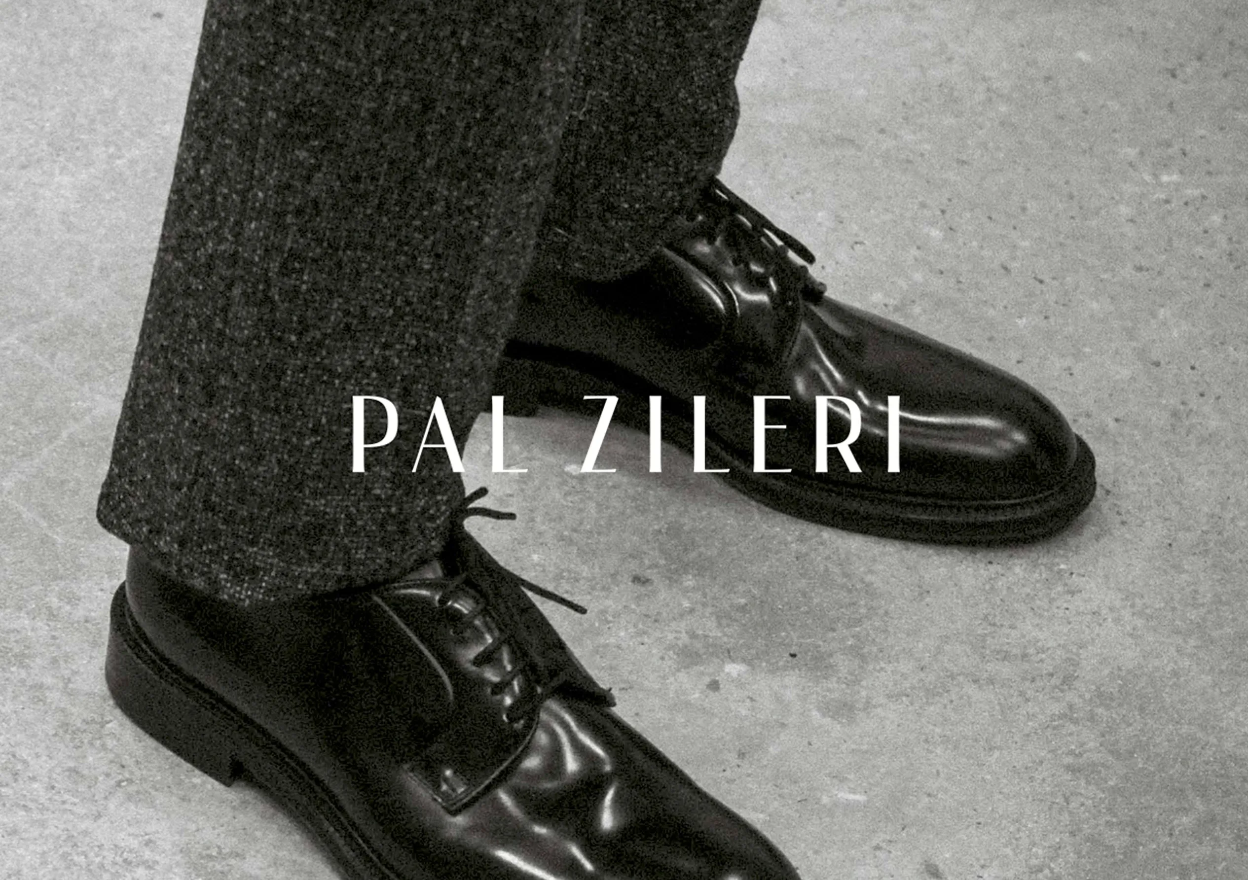 Detail of the book cover: polished black lace-up shoes and grey wool trousers on a concrete floor, with the Pal Zileri wordmark in thin capitals.